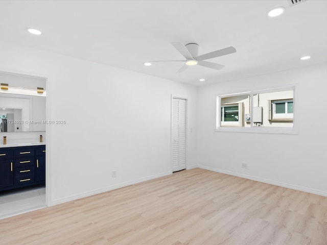 unfurnished room with ceiling fan and light hardwood / wood-style floors