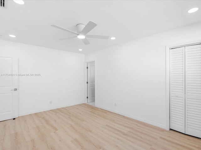 unfurnished room with ceiling fan and light wood-type flooring