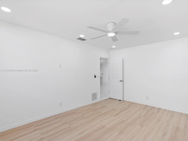 unfurnished room with ceiling fan and light wood-type flooring