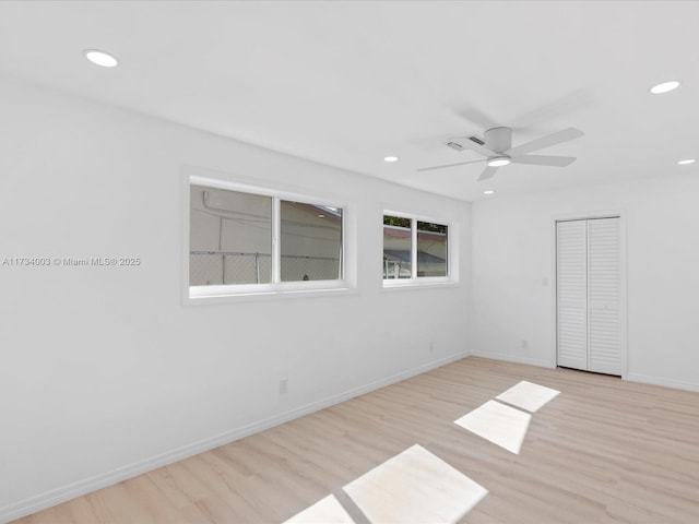 spare room featuring ceiling fan and light wood-type flooring