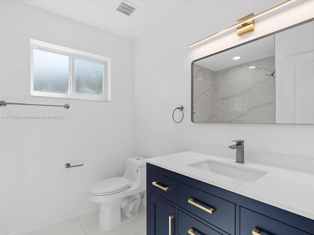 bathroom featuring tile patterned flooring, vanity, walk in shower, and toilet