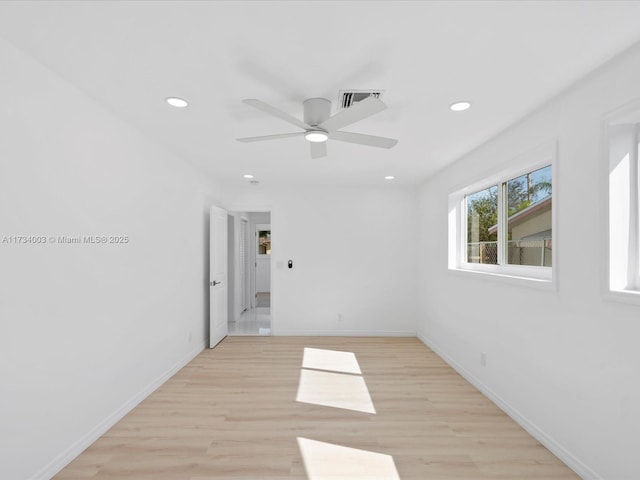 spare room featuring light hardwood / wood-style flooring and ceiling fan