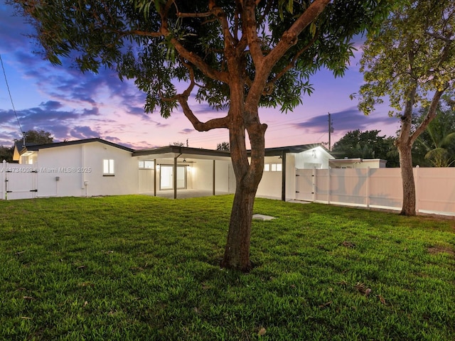 yard at dusk with a patio