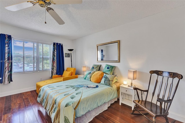 bedroom with dark wood-type flooring, ceiling fan, and a textured ceiling