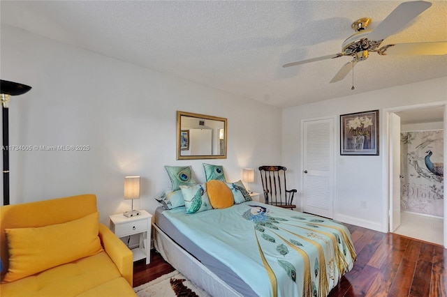 bedroom with a textured ceiling, wood-type flooring, ceiling fan, and ensuite bathroom