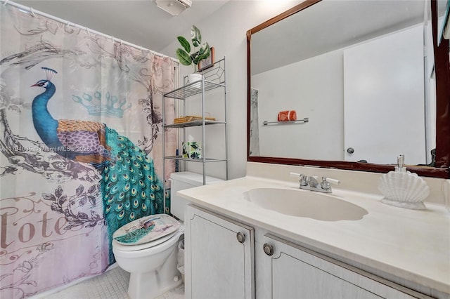 bathroom with vanity, tile patterned floors, and toilet