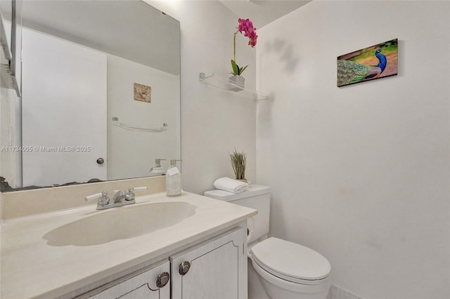 bathroom featuring vanity and toilet