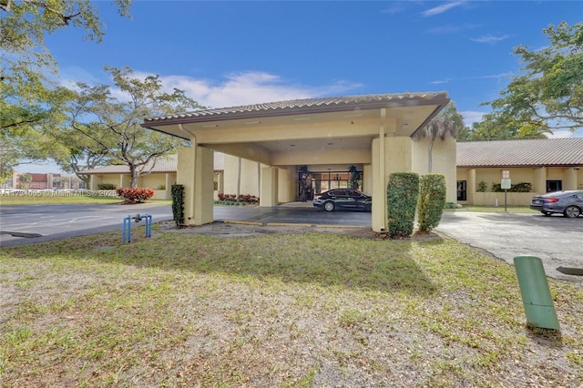 view of property exterior featuring a carport and a yard