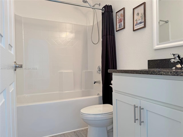 full bathroom featuring vanity, hardwood / wood-style floors, shower / tub combo with curtain, and toilet