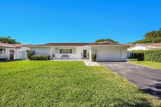 ranch-style house featuring a garage and a front yard