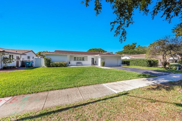 single story home featuring a garage and a front lawn