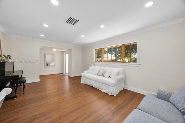 living room with crown molding and hardwood / wood-style floors