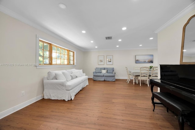 living room featuring crown molding and wood-type flooring