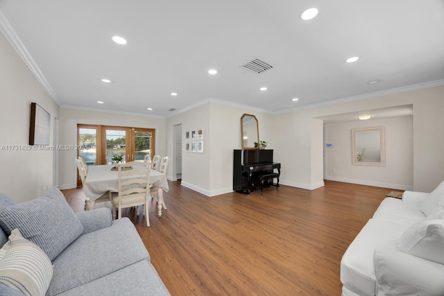 living room with crown molding, wood-type flooring, and french doors