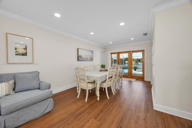 dining area featuring dark hardwood / wood-style floors, ornamental molding, and french doors