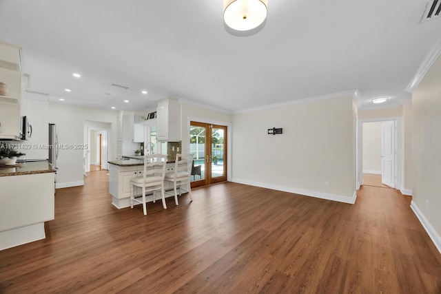 interior space featuring french doors, dark hardwood / wood-style floors, and white cabinets