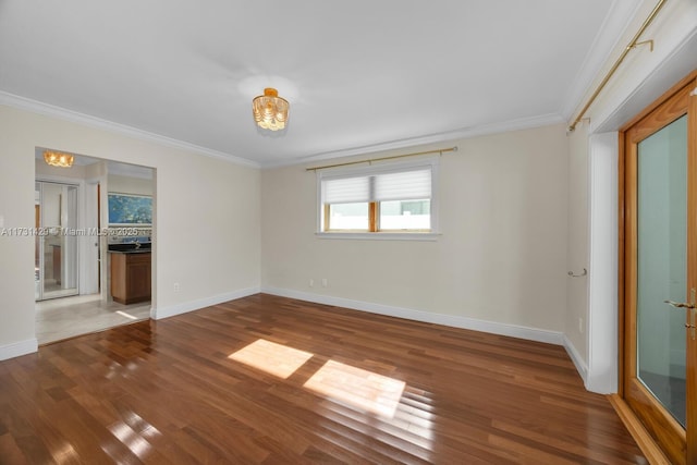 spare room with ornamental molding and dark wood-type flooring