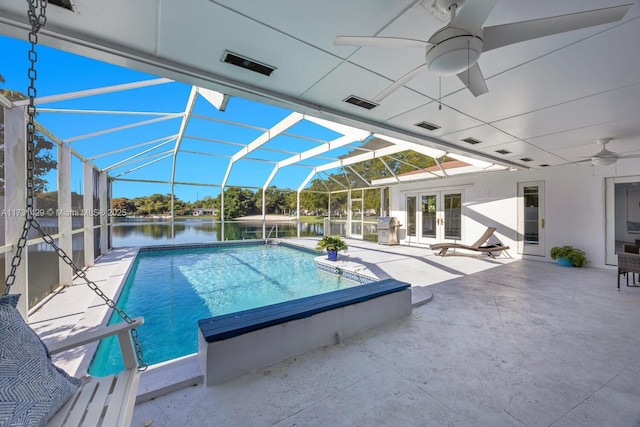 view of pool with a water view, glass enclosure, ceiling fan, a grill, and a patio