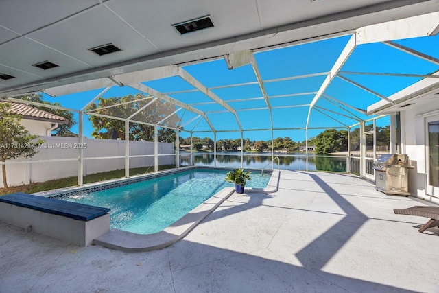 view of pool with area for grilling, a patio, a water view, and glass enclosure