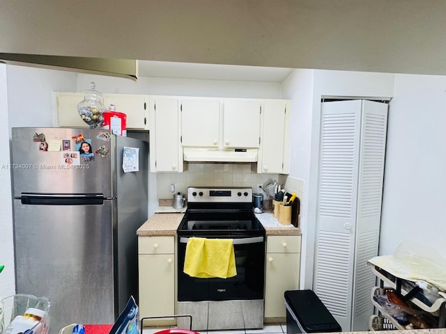 kitchen with decorative backsplash, stainless steel appliances, and white cabinets