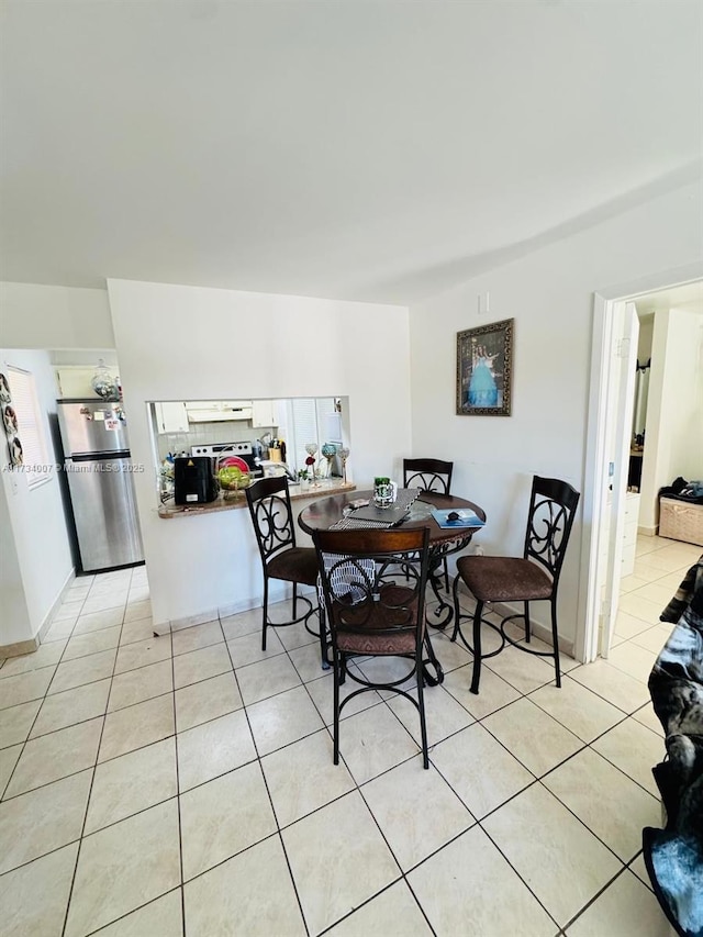 dining space featuring light tile patterned floors