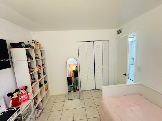 tiled bedroom featuring a closet