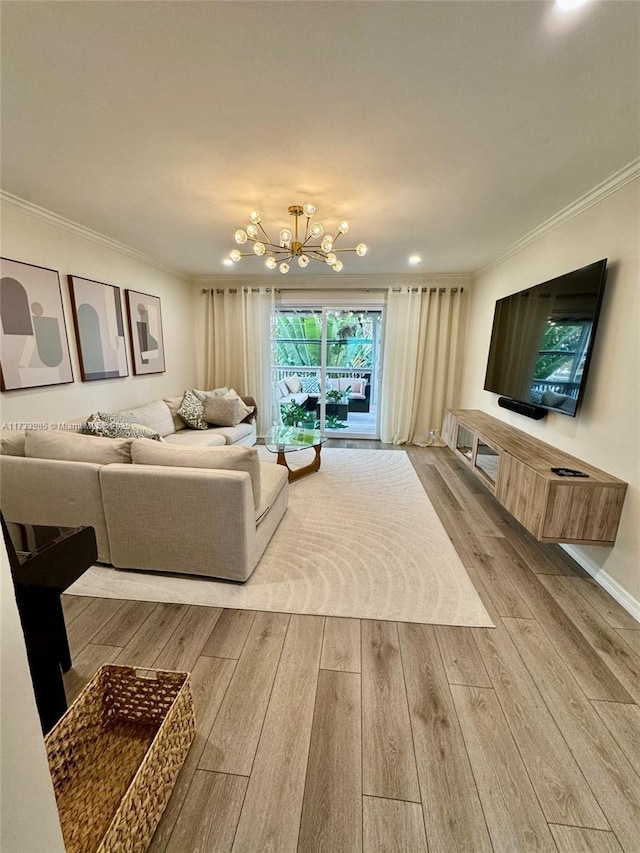 living room featuring an inviting chandelier, hardwood / wood-style floors, and ornamental molding