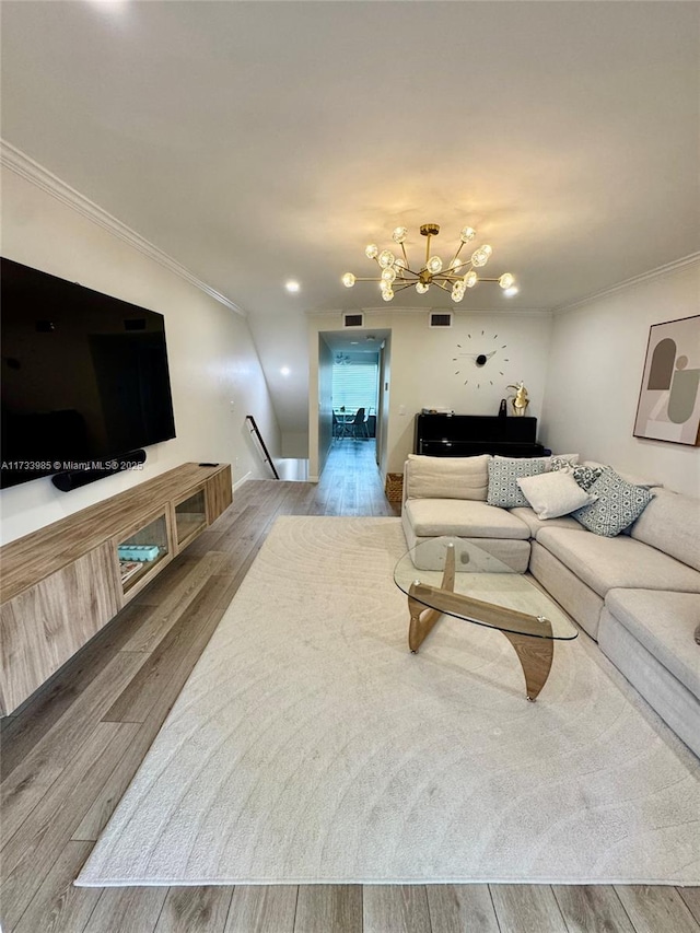 living room featuring crown molding and a notable chandelier