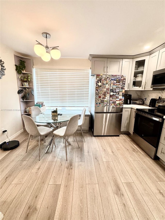 kitchen with stainless steel appliances and light hardwood / wood-style floors