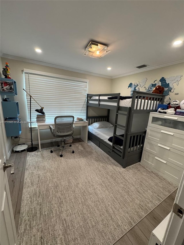 bedroom featuring crown molding and wood-type flooring