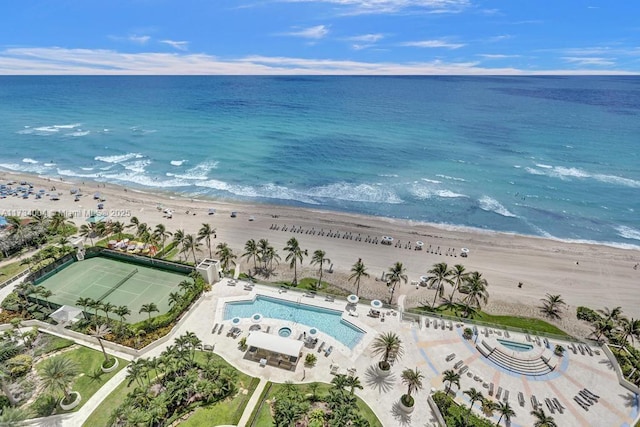 bird's eye view featuring a water view and a beach view