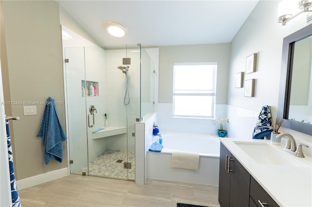 full bath featuring a garden tub, vanity, wood finished floors, and a stall shower