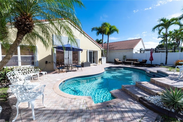 view of pool with a patio, fence, and a fenced in pool