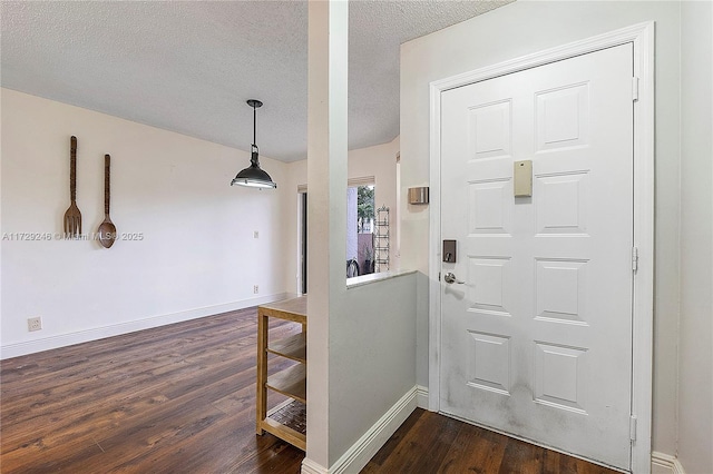 foyer featuring dark wood-type flooring and a textured ceiling