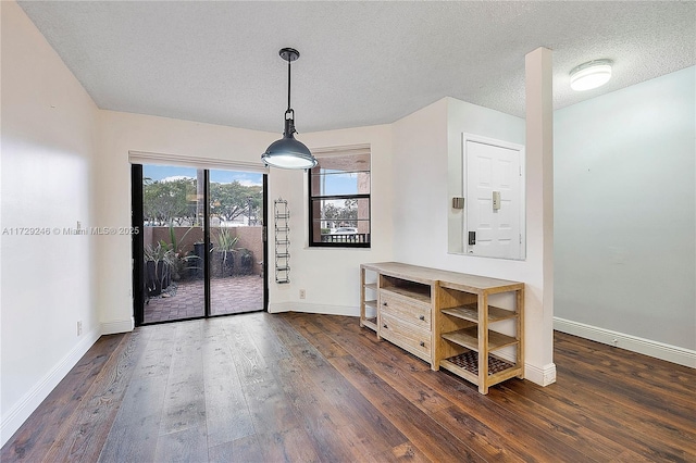 interior space with dark wood-type flooring and a textured ceiling