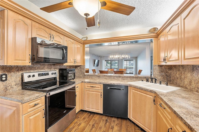 kitchen with light brown cabinetry, sink, decorative light fixtures, light wood-type flooring, and black appliances