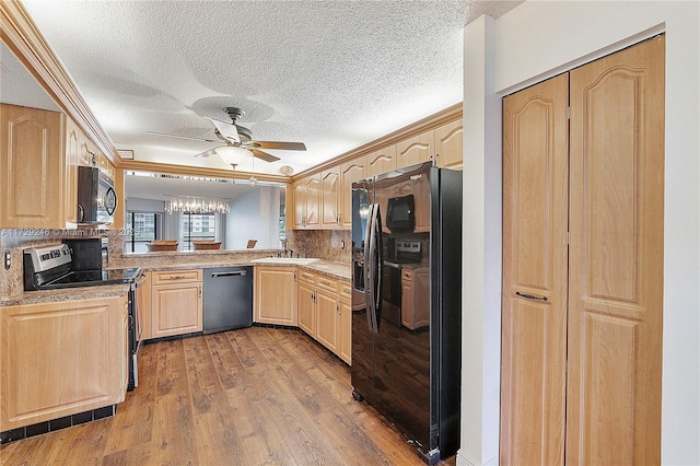 kitchen with sink, light brown cabinets, backsplash, and black appliances