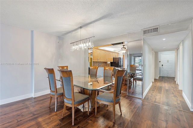 dining area featuring ceiling fan, dark hardwood / wood-style floors, and a textured ceiling