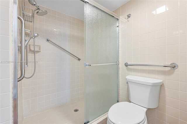 bathroom featuring tile walls, an enclosed shower, and toilet