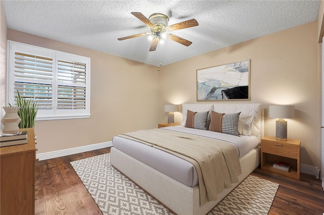 bedroom featuring dark hardwood / wood-style floors, a textured ceiling, and ceiling fan