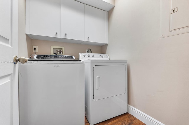 washroom featuring cabinets, wood-type flooring, and washer and dryer