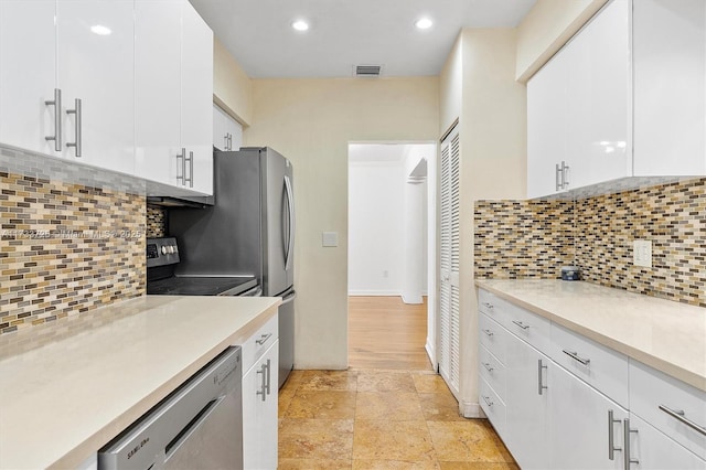 kitchen with visible vents, appliances with stainless steel finishes, white cabinets, and light countertops