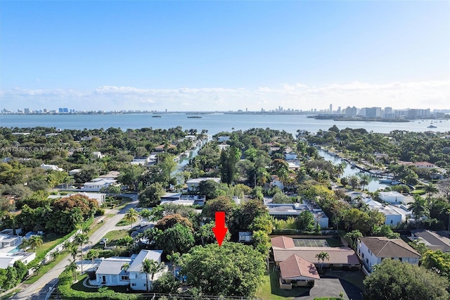 birds eye view of property featuring a water view and a city view