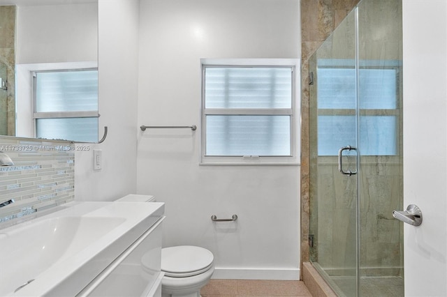 bathroom with baseboards, a shower stall, toilet, and vanity