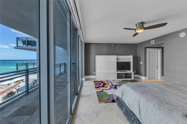 bedroom with floor to ceiling windows, a water view, and ceiling fan