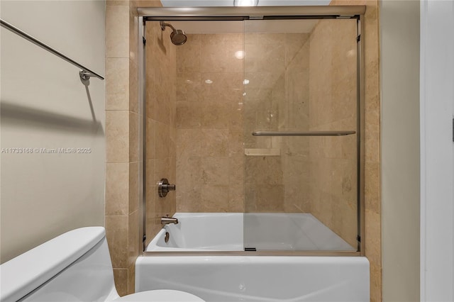 bathroom featuring enclosed tub / shower combo and toilet