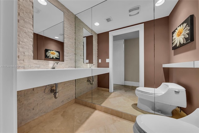 bathroom featuring tile patterned flooring and toilet