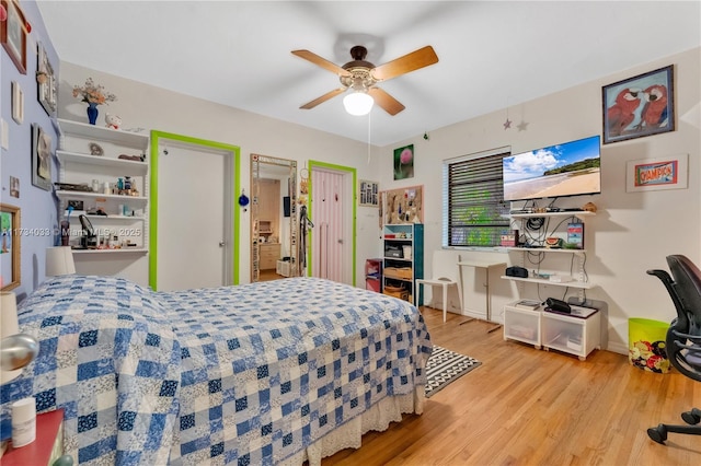 bedroom with ceiling fan and light hardwood / wood-style flooring