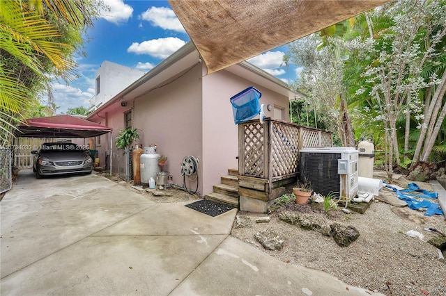 exterior space featuring a carport and central AC unit