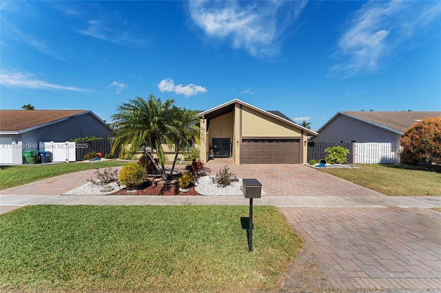 single story home with a garage and a front lawn